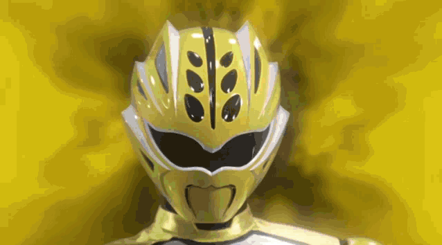 a yellow power ranger with a black and white helmet