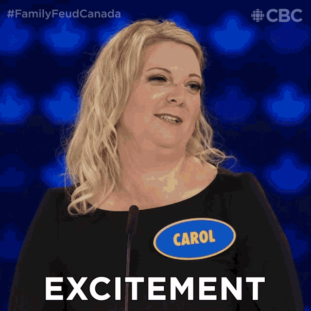 a woman with a name tag that says carol stands in front of a microphone