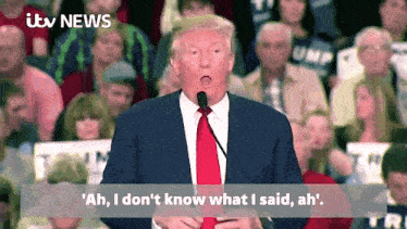 a man in a suit and tie is giving a speech in front of a crowd with itv news written on the bottom