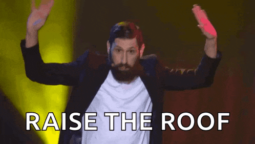 a man with a beard is raising his hands in the air with the words raise the roof behind him