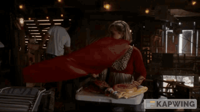 a woman holding a red flag says " i mean clark kent airlines "