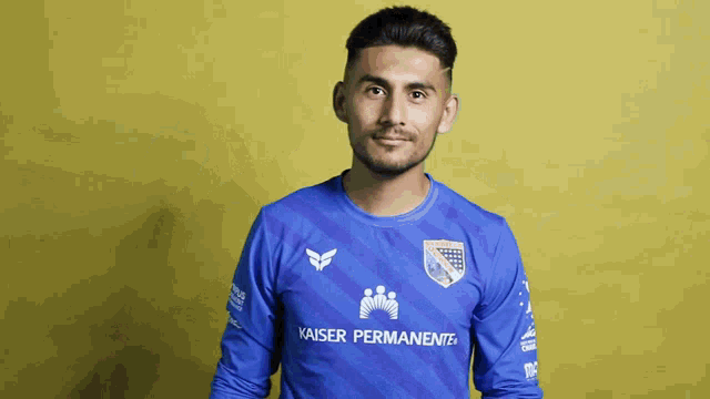 a man in a blue kaiser permanente jersey