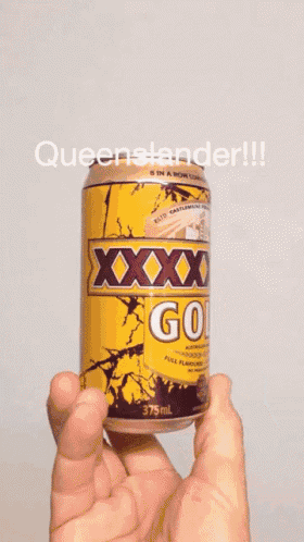 someone is holding a can of xxx old beer in their hand