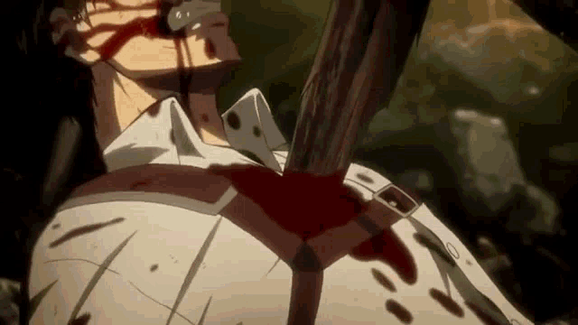 a close up of a person with blood coming out of their mouth holding a stick .