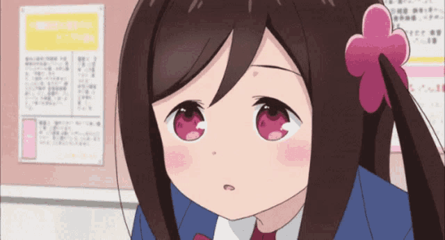 a girl with a pink flower in her hair is looking at something