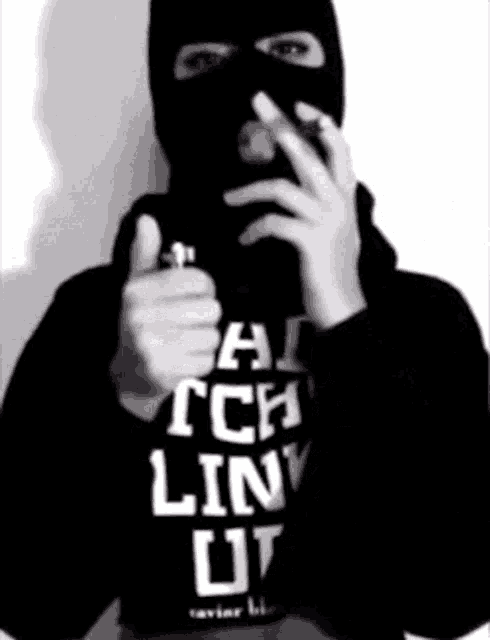 a man wearing a ski mask is smoking a cigarette and holding a lighter in his hand