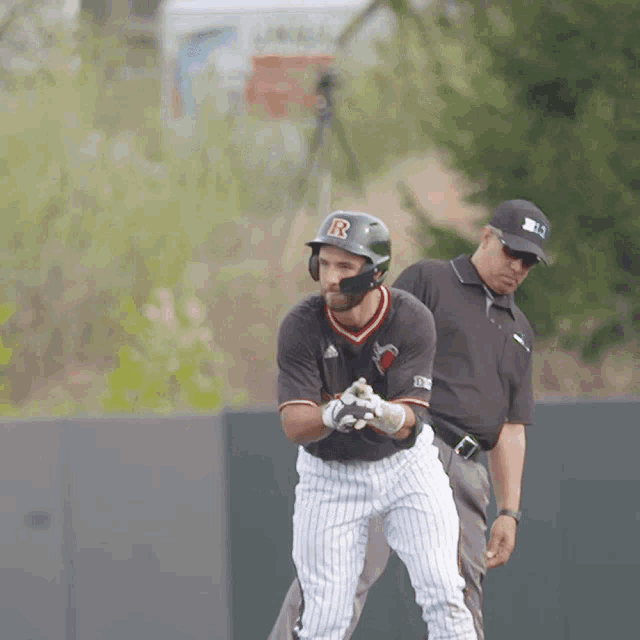 a baseball player wearing a helmet with a letter r on it