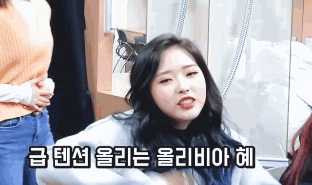 a girl with korean writing on her face holds her stomach