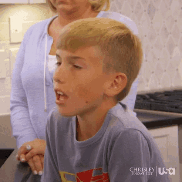 a young boy in a chrisley knows best shirt looks at something