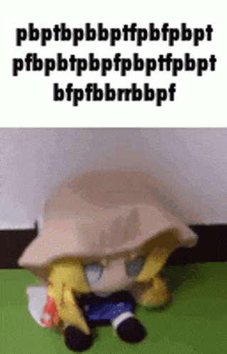 a stuffed animal is laying on the floor with a hat on .