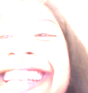 a close up of a woman 's face with a blurred background