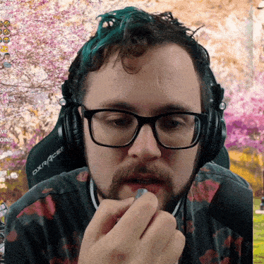 a man wearing glasses and headphones with the word dxracer on them
