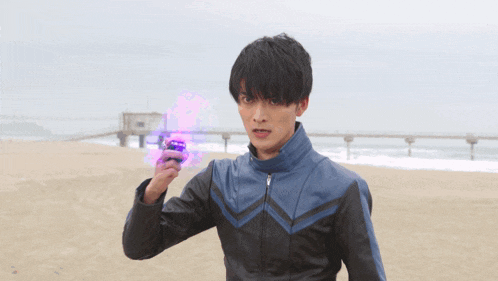 a young man in a leather jacket holds a purple object in his hand