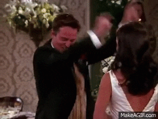 a man in a tuxedo is dancing with a woman in a white dress
