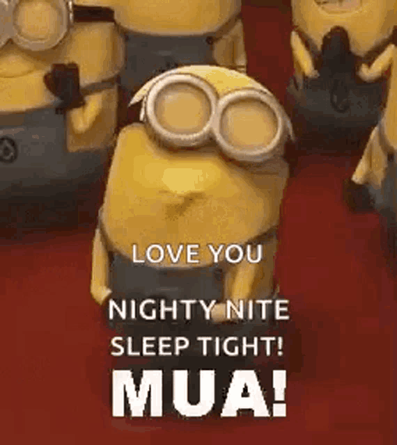 a group of minions are standing next to each other on a red carpet and one of them is wearing goggles .