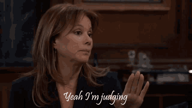a woman says " yeah i 'm judging " with her hands outstretched