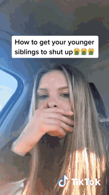 a woman in a car covering her mouth with her hand and a tiktok logo on the bottom right