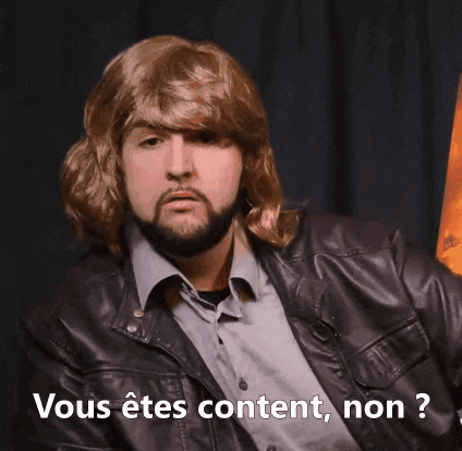 a man wearing a wig and a leather jacket says " vous êtes content non "