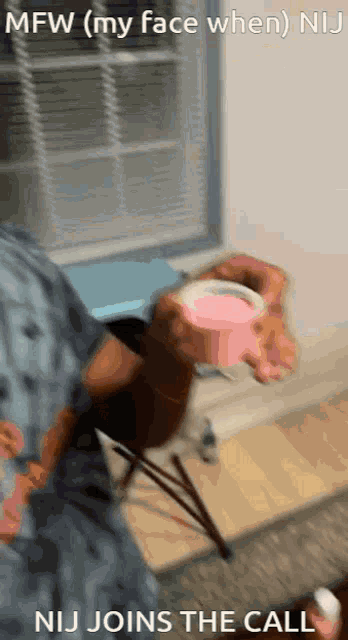 a person holding a pink cup with the words mfw ( my face when ) nij joins the call on the bottom
