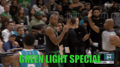 a basketball player stands in front of a crowd and says green light special