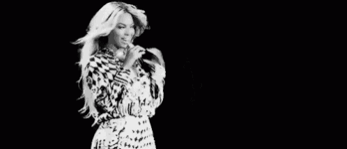 a black and white photo of a woman in a dress dancing .