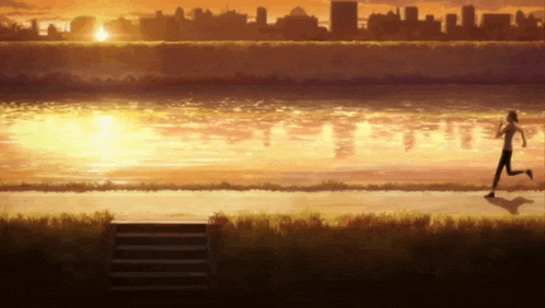 a person running on a path near a body of water at sunset