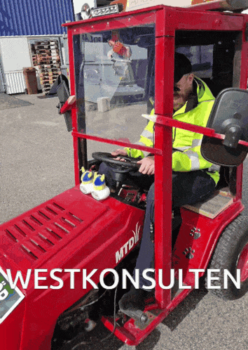 a man is driving a red mtd tractor