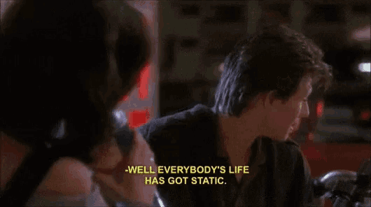 a man talking to a woman with the words well everybody 's life has got static