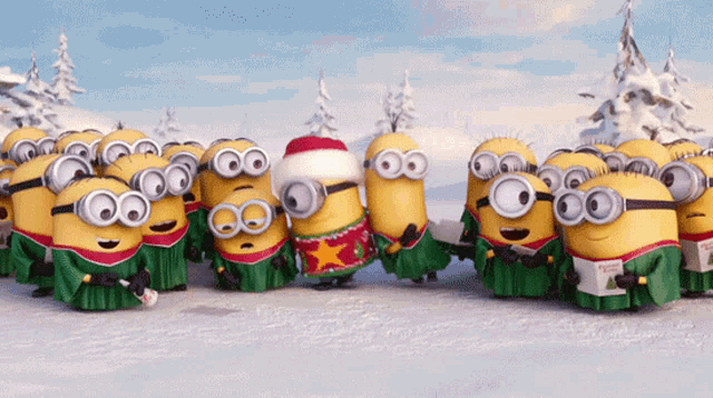 a group of minions are standing in the snow wearing sweaters and goggles