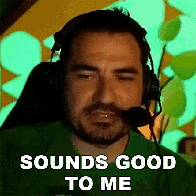 a man wearing headphones and a microphone with the words `` sounds good to me '' written on his face .