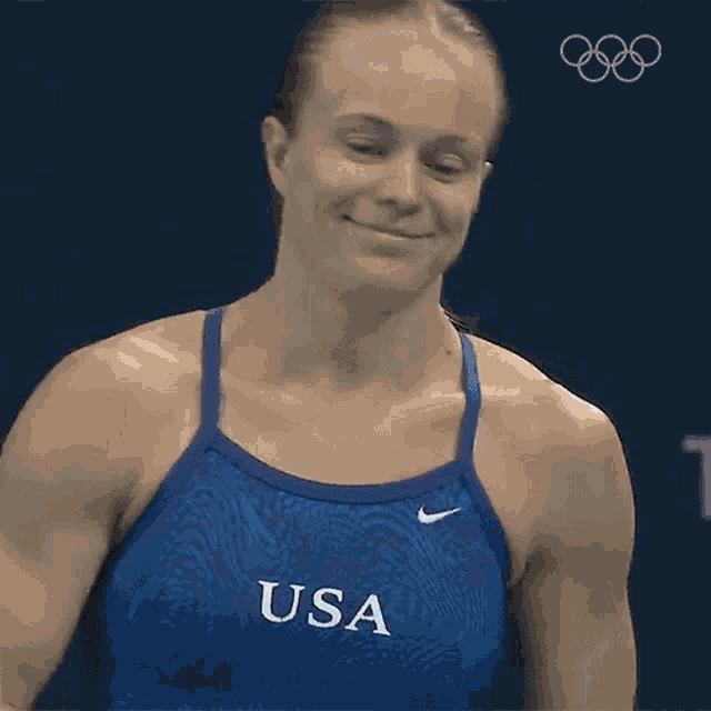 a woman wearing a blue tank top with usa written on it