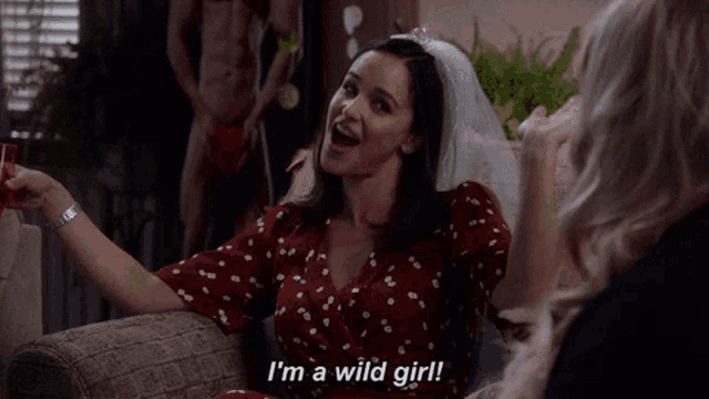 a woman with a veil on her head says " i 'm a wild girl "