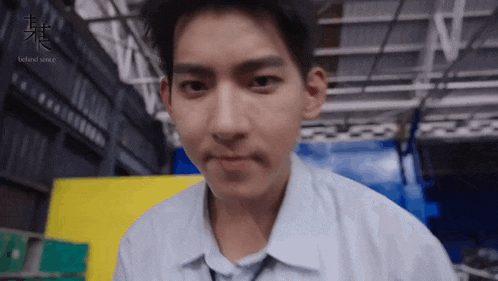 a young man in a white shirt and tie is making a funny face
