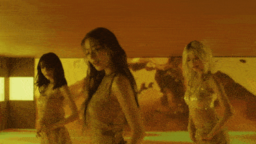 a group of women are dancing in a room with red and yellow walls