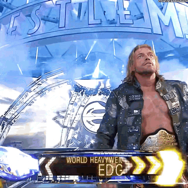 a man stands in front of a world heavyweight edc sign