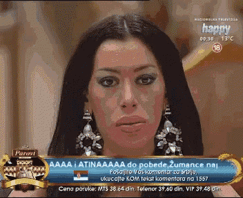 a television screen shows a woman with earrings and the words happy on the bottom