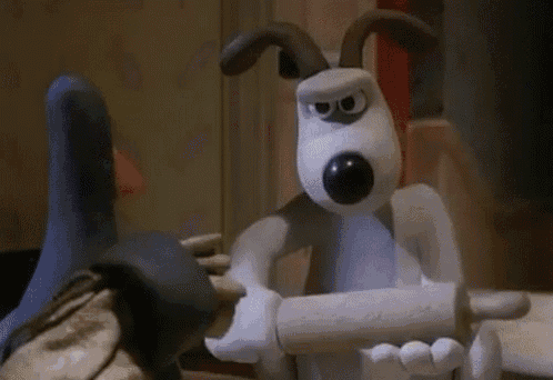 a cartoon dog is holding a wooden rolling pin in his hands .