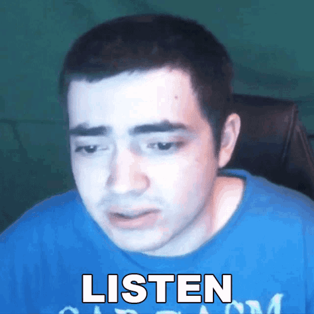 a man in a blue shirt says listen