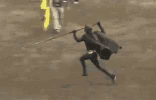 a man is standing next to a bull in a bullfight .