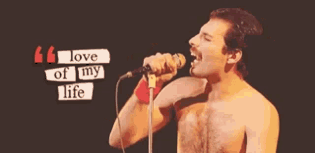 a shirtless man singing into a microphone with a quote behind him that says " love of my life "