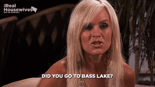 a blonde woman is sitting in front of a sign that says real housewives out of context