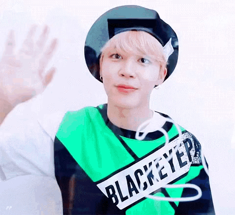 a person wearing a green black and white shirt that says blackeye