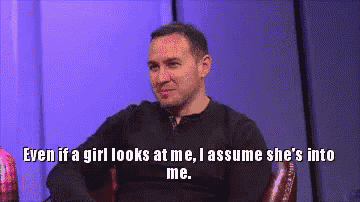 a man sitting in a chair with the words even if a girl looks at me