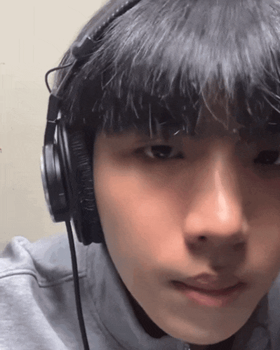a man wearing headphones looks at the camera