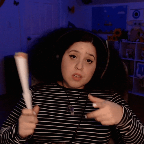 a woman holding a fan with the words that would be fire on the bottom