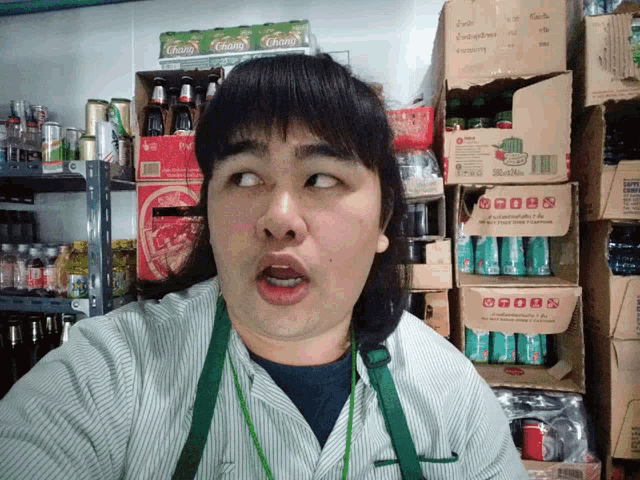 a man making a face in front of boxes of chang
