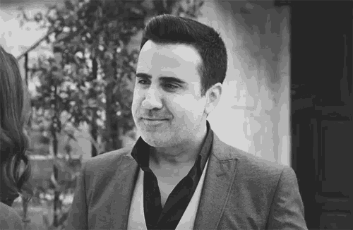 a black and white photo of a man in a suit