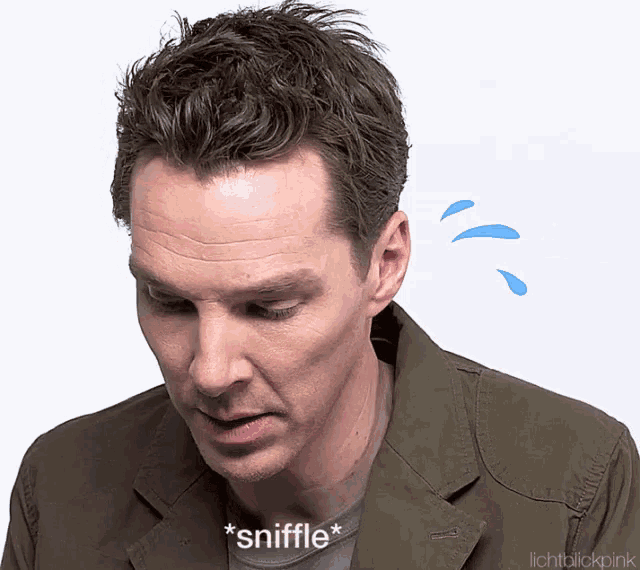 a man in a green jacket says * sniffle * on his face