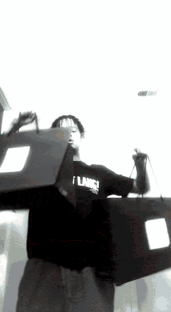 a man wearing a shirt that says i lance is holding a box