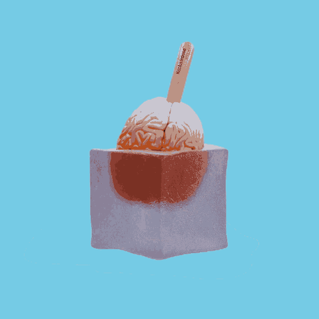 an ice cream cone with a brain on top of it and a stick that says kickfrost